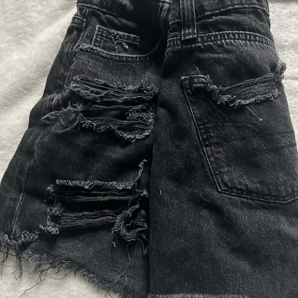 womens black distressed shorts with crossover design